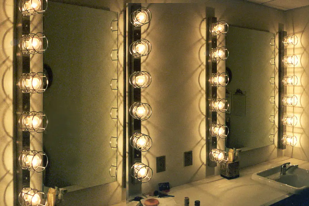 A well lit bathroom with mirrors on the wall showcasing dressing room light fixtures - How to Choose Dressing Room Light Fixtures? - Vorlane