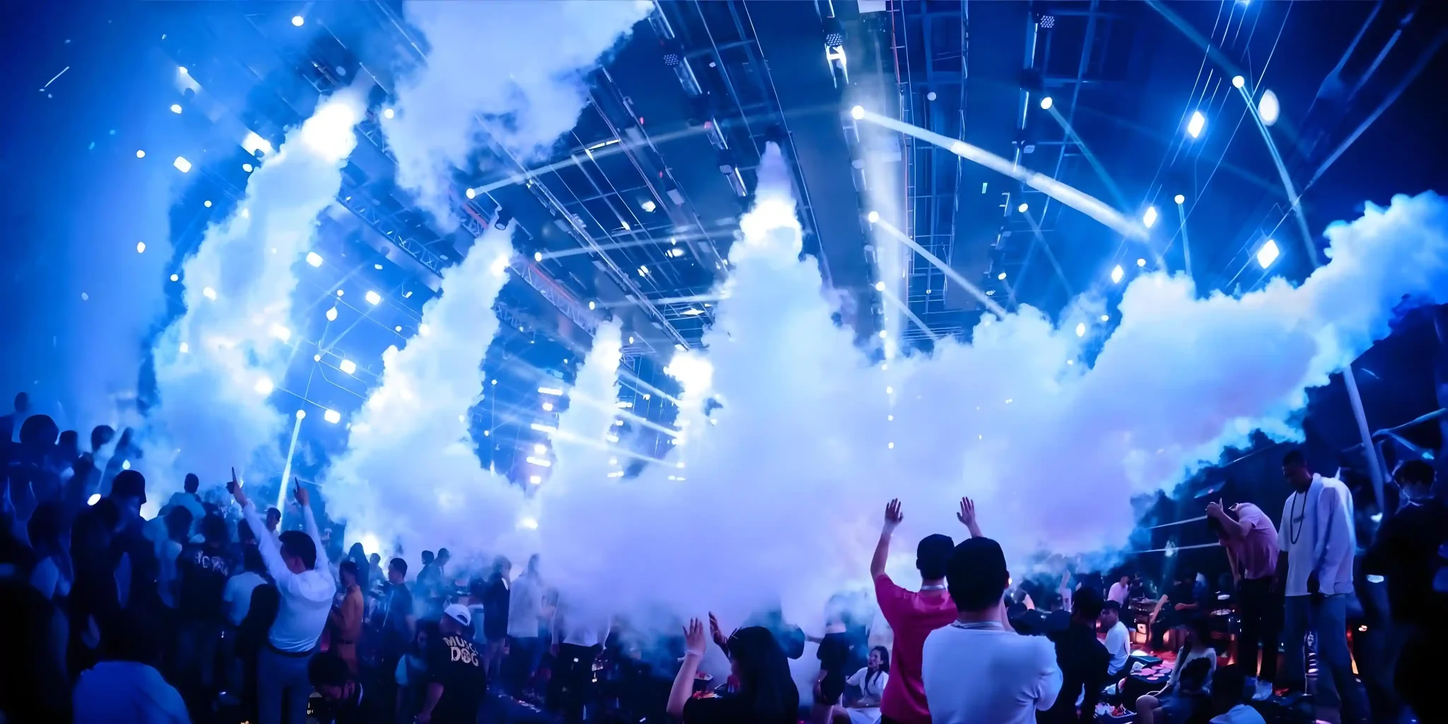 Indoor nightclub party with fog machine and lively lighting effects