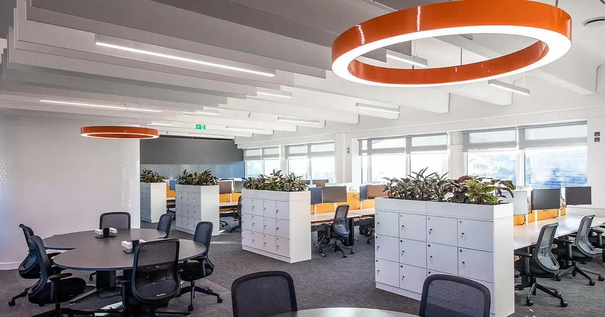 Office with orange lighting and black chairs meeting UK Workplace Lighting Regulations - Workplace Lighting Regulations in the UK: Ensuring Safety and Productivity - Vorlane