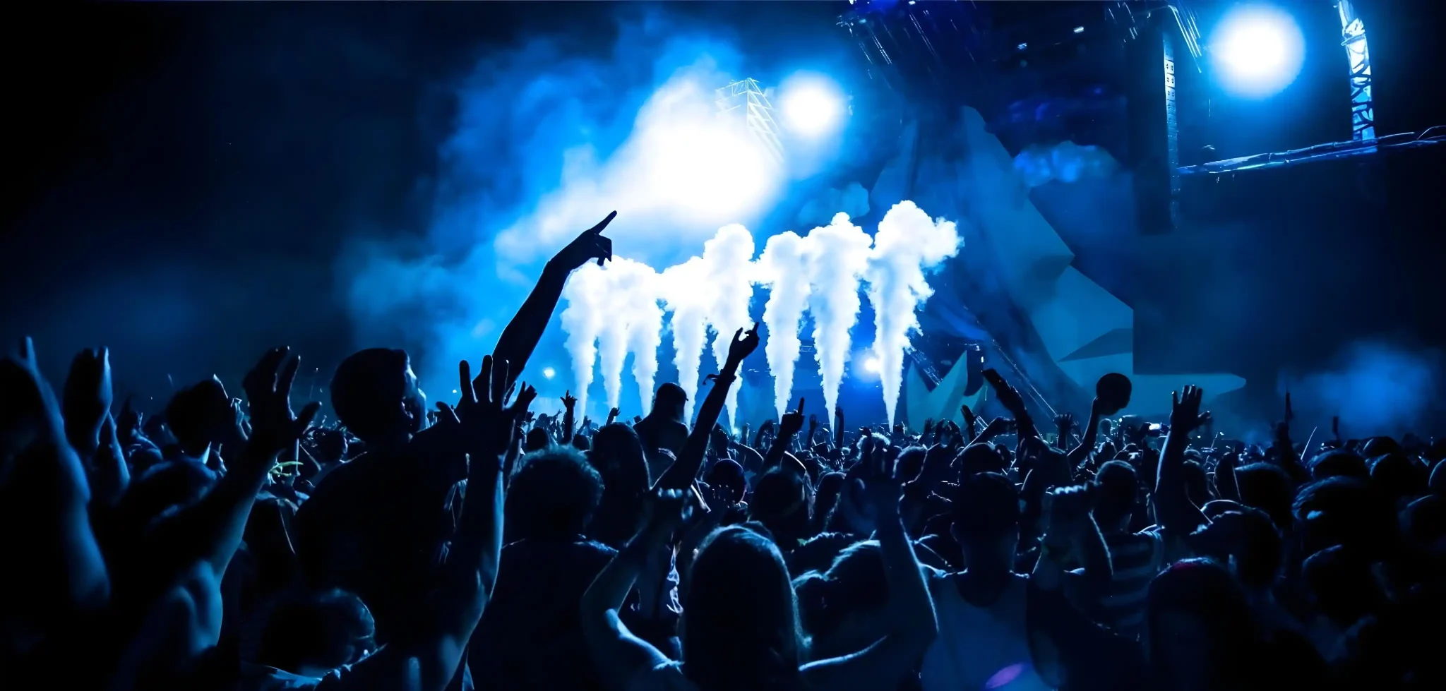 Outdoor music festival with fog effects and dynamic lighting display